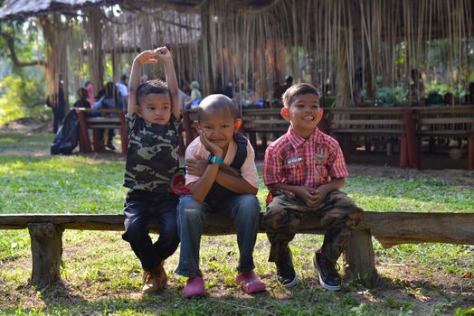 Carey Island, Selangor/Malaysia - Mar 17 2018: Mah Meri children sit at wooden block.