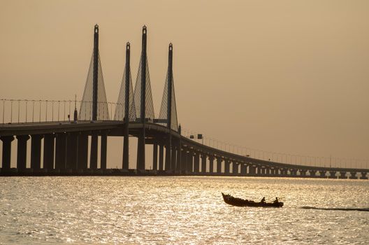 George Town, Penang/Malaysia - Dec 28 2019: Fishing boat move near Penang second Bridge.