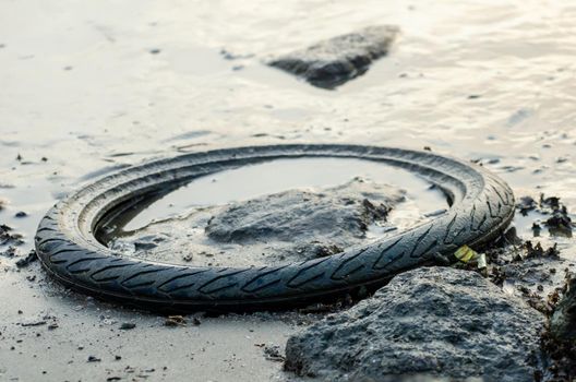 Batu Maung, Penang/Malaysia - Dec 28 2019: Car tire as rubbish at seaside.