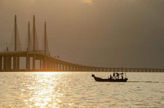 George Town, Penang/Malaysia - Dec 30 2019: A fishing boat move toward Penang second Bridge main span.