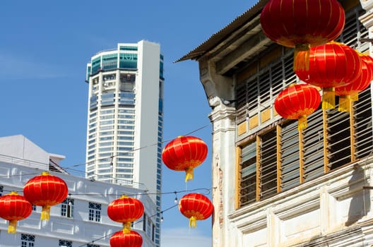 Georgetown, Penang/Malaysia - Jan 03 2020: Red lantern decorated near old heritage house. Background is KOMTAR building.