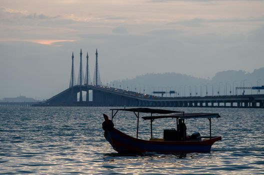 Georgetown, Penang/Malaysia - Feb 15 2020: Fishing boat at Penang Bridge.