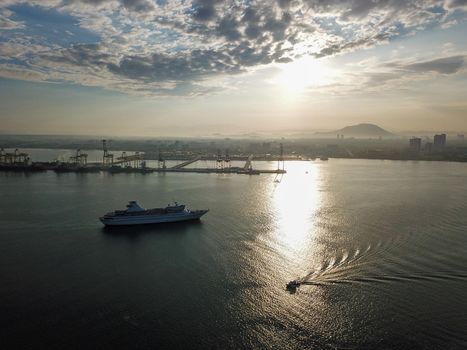 Georgetown, Penang/Malaysia - Feb 28 2020: Boat and cruise ship at sea near container terminal Butterworth.