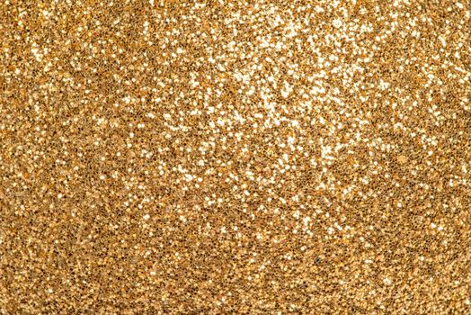 Detailed texture of golden glitter dust surface, luxury background