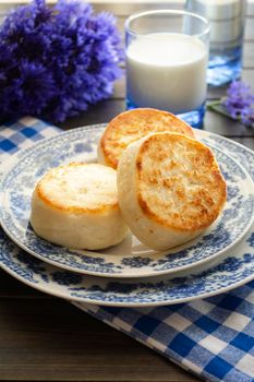 Cottage cheese pancakes with blue cornflower, breakfast or lunch. Vertical image