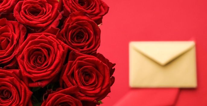 Holiday gift, flowers flatlay and happy relationship concept - Love letter and flower delivery service on Valentines Day, luxury bouquet of red roses and card envelopes on red background