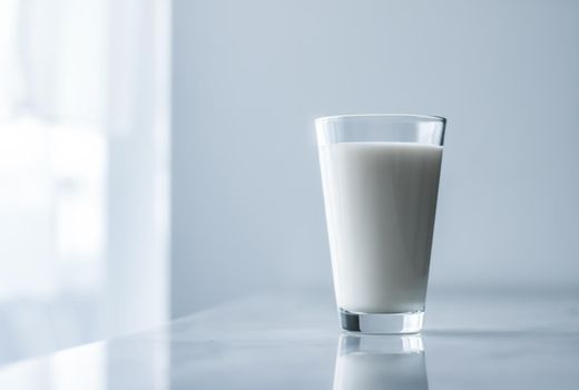 Dairy, healthy nutrition and breakfast concept - World Milk Day, full glass on marble table