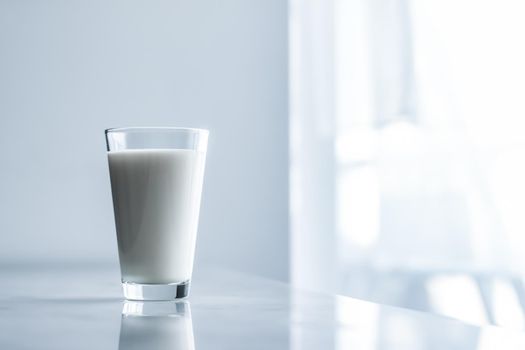 Dairy, healthy nutrition and breakfast concept - World Milk Day, full glass on marble table