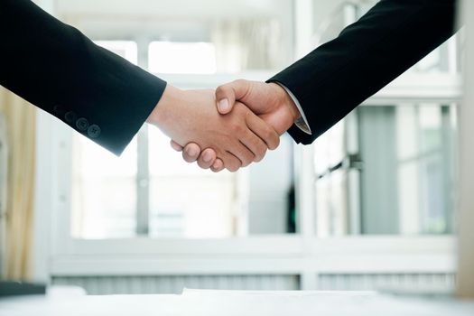 Businessmans handshake. Successful businessmen handshaking after good deal. Business partnership meeting concept.