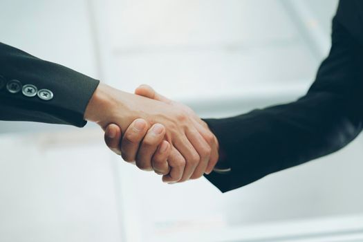 Businessmans handshake. Successful businessmen handshaking after good deal. Business partnership meeting concept.