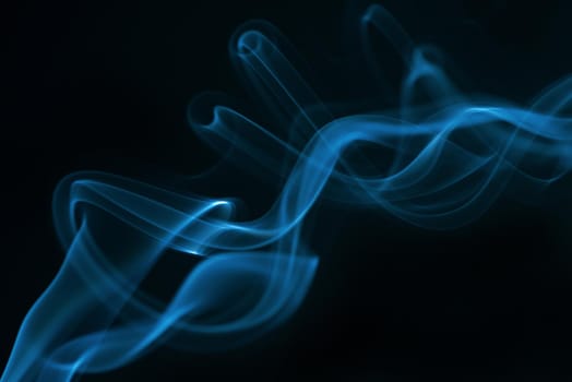 Blue smoke isolated on black background.