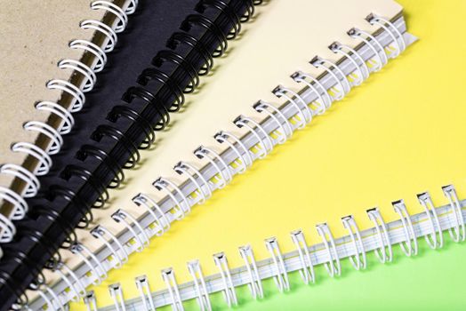 Stack of colourful notebooks with spiral edge, school or educational background
