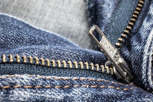 metallic zipper on blue jeans
