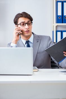 Businessman employee talking on the office phone