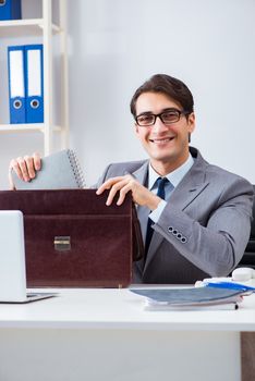 Young handsome businessman employee working in office at desk