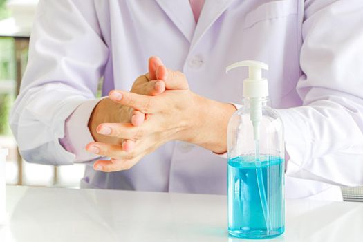 Asian scientist or medical researcher Test concept for producing 75% alcohol-based hand sanitizer for hand washing in case of sterilization of bacteria and preventing the coronavirus, COVID-19