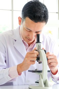 Asian scientists or chemists use a microscope. In science experiment Medical pharmaceutical research concept DNA structure, innovation and technology