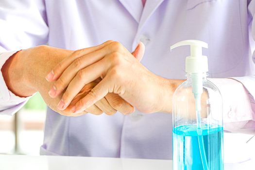 Asian scientist or medical researcher Test concept for producing 75% alcohol-based hand sanitizer for hand washing in case of sterilization of bacteria and preventing the coronavirus, COVID-19