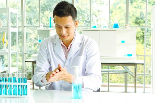 Asian scientist or medical researcher Test concept for producing 75% alcohol-based hand sanitizer for hand washing in case of sterilization of bacteria and preventing the coronavirus, COVID-19