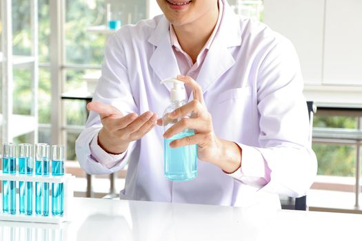 Asian scientist or medical researcher Test concept for producing 75% alcohol-based hand sanitizer for hand washing in case of sterilization of bacteria and preventing the coronavirus, COVID-19