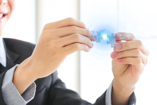 A close up of a businessman holding a piece of the puzzle Business problem-solving concept in office Brainstorming success concepts strategy