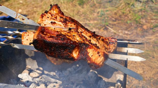 A meal or gathering at which meat, fish, or other food is cooked out of doors on a rack over an open fire or on a portable grill.Delicious piece of meat fried over the fire at a picnic. 