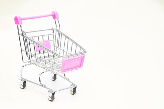 Isolated shopping cart for folding groceries on white background. High quality photo. The action or activity of purchasing goods from stores.