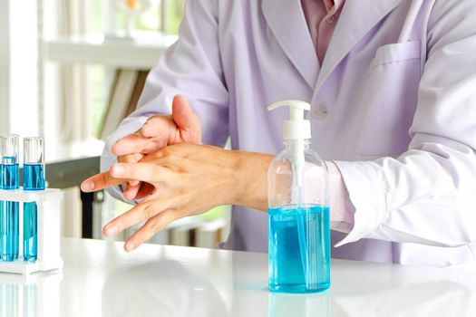 Asian scientist or medical researcher Test concept for producing 75% alcohol-based hand sanitizer for hand washing in case of sterilization of bacteria and preventing the coronavirus, COVID-19