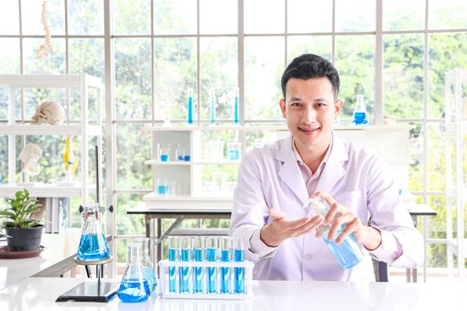 Asian scientist or medical researcher Test concept for producing 75% alcohol-based hand sanitizer for hand washing in case of sterilization of bacteria and preventing the coronavirus, COVID-19