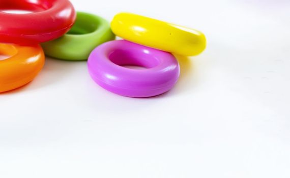 a group of of five colorful plastic rings isolated on a white background. Children's toys. Same size for each ring