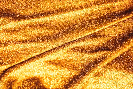 Luxe glowing texture, night club branding and New Years party concept - Golden holiday sparkling glitter abstract background, luxury shiny fabric material for glamour design and festive invitation