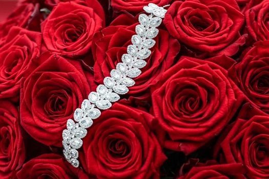 Gemstone jewellery, wedding fashion and luxe shopping concept - Luxury diamond bracelet and bouquet of red roses, jewelry love gift on Valentines Day and romantic holidays present