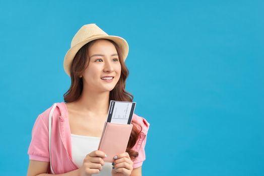 Portrait of young asian woman holding passport and smile. Happy people and travel concept.