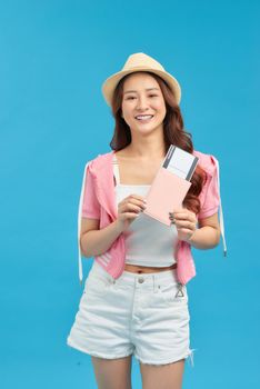 Portrait of young asian woman holding passport and smile. Happy people and travel concept.