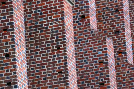 Close-up on the wall of a red brick building. Background