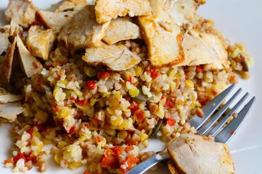 Pieces of cooked meat and healthy porridge on the table