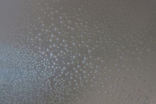 Out of focus. Blurred background. Bubbles on the sides of the cookware when the water is heating