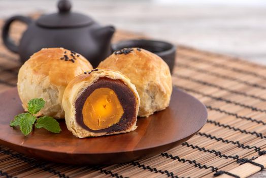 Close up of Moon cake yolk pastry, mooncake for Mid-Autumn Festival holiday on wooden table background