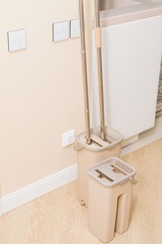 Modern buckets with mops. Cleaning of premises. Close-up