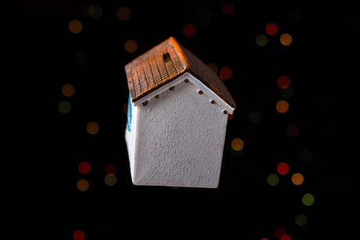 Little model house on a bokeh light background