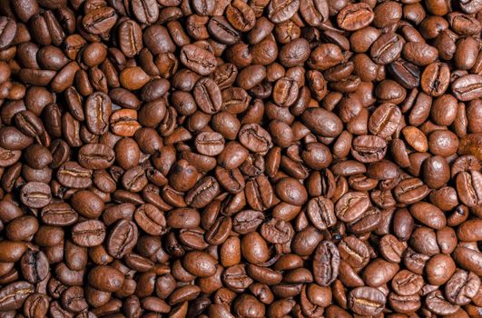 Fresh brown roasted coffee beans flat background