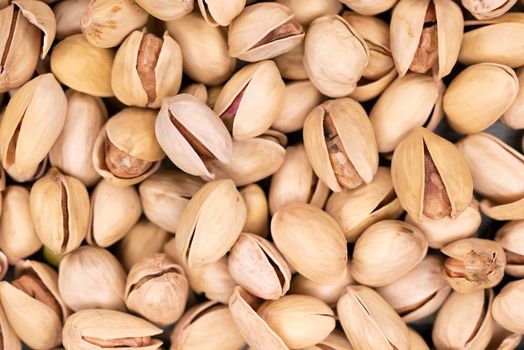 Roasted and salted pistachios in shell background