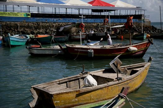 salvador, bahia, brazil - june 28, 2021: Fishing boats are seen moored in a port at Feira de Sao Joaquim in Salvador city.


