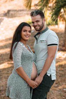 Photo of a young couple, the girl is pregnant