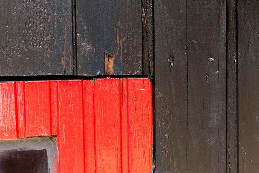 Red and black wooden wall with diferent color pattern.