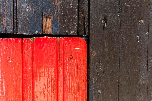 Red and black wooden wall with diferent color pattern.