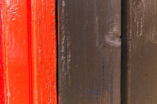 Red and black wooden wall with diferent color pattern.