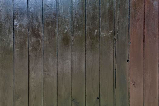 Black wooden wall with diferent color pattern.