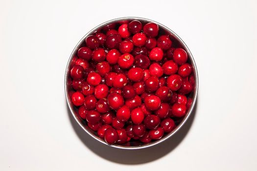 Bowl of cherries on a white background. Red cherries. Bowl placed in the midlle of the frame