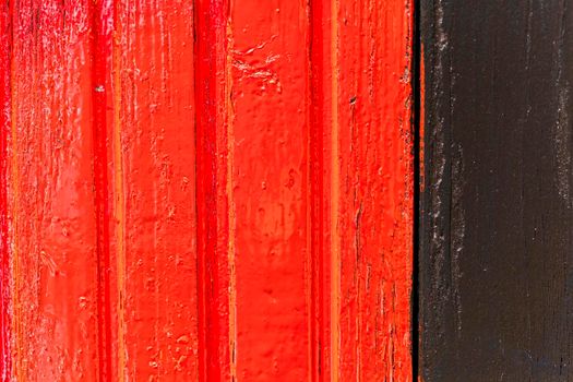 Red and black wooden wall with diferent color pattern.